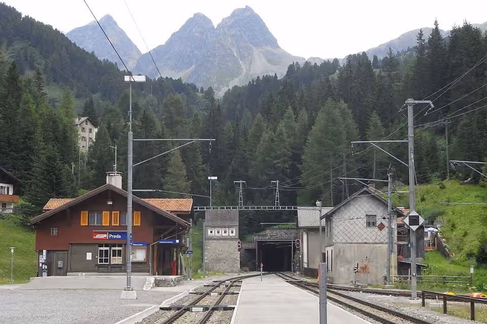 La gare de Preda et ses voies ferrées dans un paysage alpin des Grisons, en Suisse.